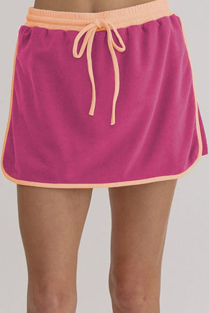 Pink sweatshirt skort with contrast trim and drawstring waist.