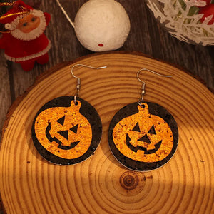 Glitter pumpkin Halloween dangle earrings in tangerine orange with black backing.