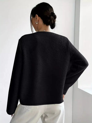 Black textured button-up fleece outerwear with long sleeves and a crew neckline.