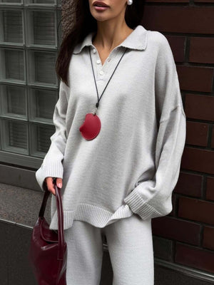 Grey knit polo sweater with button detail and wide-leg pants.