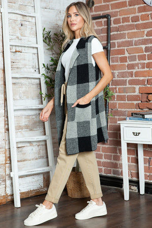Black and grey checkered knit duster vest with pockets and a shawl collar.
