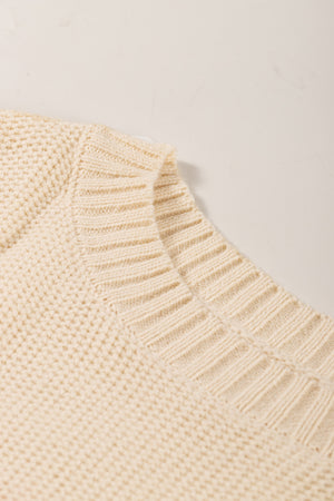 Cream ribbed knit pullover sweater with textured knit detail and ribbed neckline.