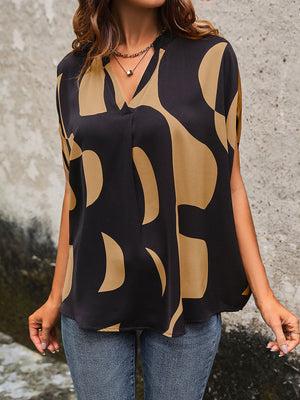 Black abstract print batwing blouse with V-neck and short sleeves.
