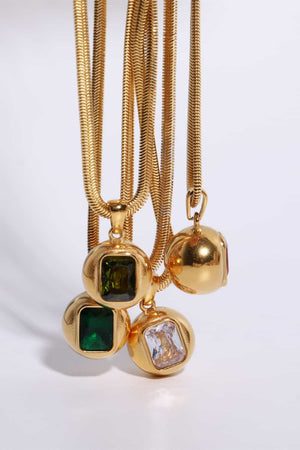 Gold snake chain necklaces with orb pendants featuring square cut gemstones in dark green, olive, and transparent.