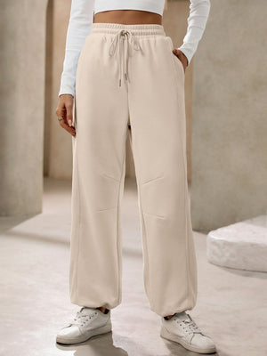 Tan balloon-leg sweatpants with drawstring waist and pockets