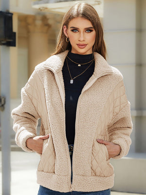 Camel quilted jacket with sherpa panels and zip front, styled with a black turtleneck.