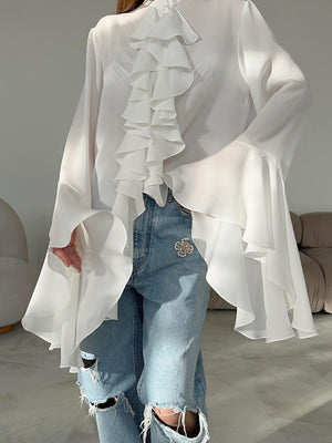 White ruffled flounce sleeve blouse with cascading ruffles and bell sleeves.