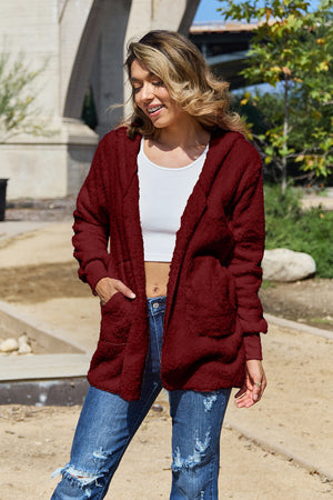 Plush hooded cardigan jacket in burgundy with pockets and cuffed sleeves.