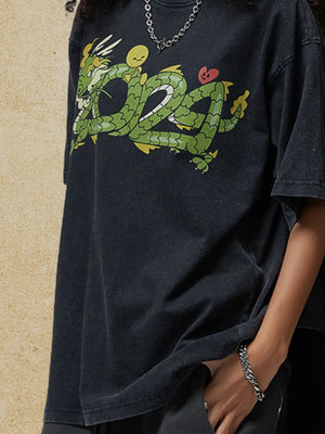 Black washed cotton tee with a bold green dragon graphic and a small red heart detail.