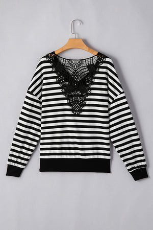 Black and white striped blouse with black lace detail on the back.