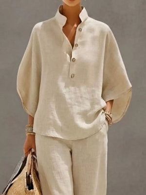Chic buttoned loungewear set in apricot, featuring a stand collar and wide sleeves.