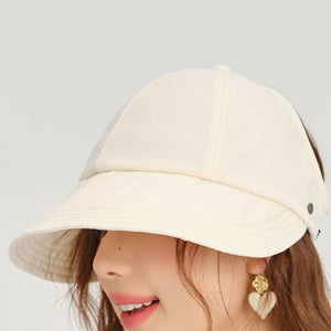 Beige sun visor hat with decorative stitching and adjustable strap