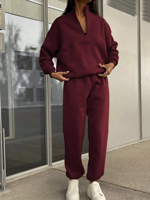 Burgundy half zip sweatshirt and matching jogger pants set with a relaxed fit.