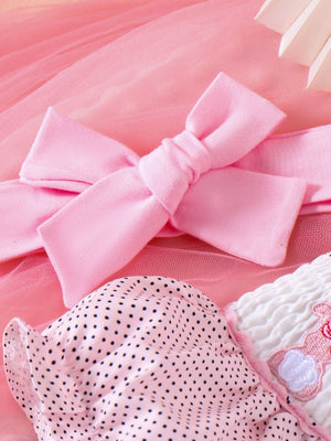 Pink baby dress with polka dots, embroidered bunny detail, and a pink bow headband.