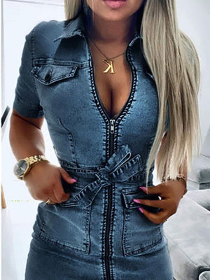 Zipper front denim shirt dress in blue with short sleeves, collar, tie waist, and chest pockets.