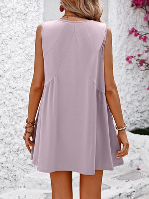Lilac trapeze mini dress with seam detail and ruffled hem.