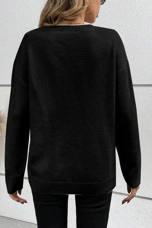 Black crewneck sweater with appliqué detail, long sleeves, and ribbed hem.