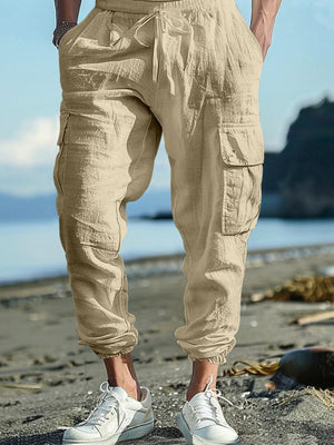 Khaki cargo pants with drawstring waist and elastic cuffs, featuring side pockets.