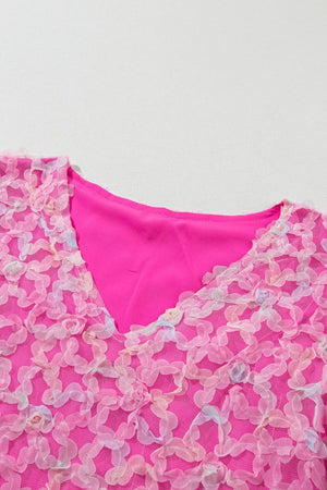 Fuchsia pink blouse with floral appliqué mesh overlay and V-neck.