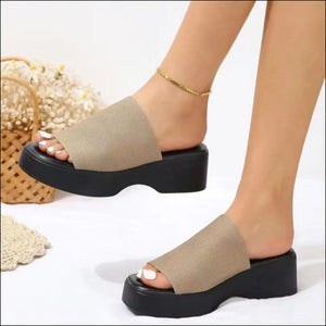 Khaki knit platform slide sandals with black soles.