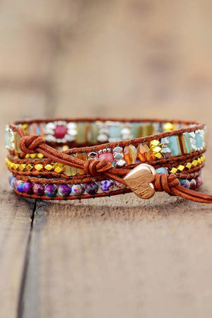 Bohemian wrap bracelet with stones, beads, and a heart charm on leather cords.