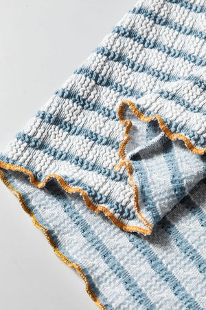 Textured stripe henley sweater in dusty blue with smocked fabric and lettuce edge trim.