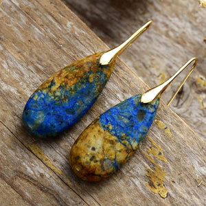 Marbled teardrop gemstone earrings in blue and brown with gold hooks.