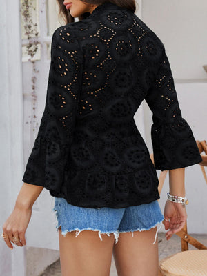 Black eyelet embroidered peplum blouse with ruffled bell sleeves and high neckline.