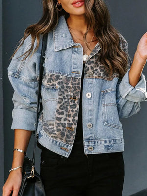 Distressed denim trucker jacket with leopard print panels and button front.