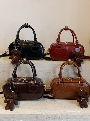 Chic mini PU leather crossbody bag in black, deep red, chocolate, and terracotta with teddy bear charm
