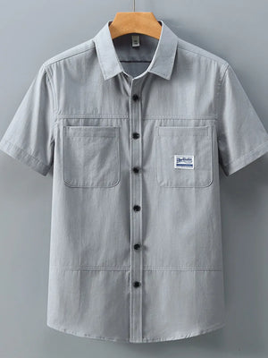 Men's grey cotton short-sleeve utility shirt with two chest pockets and button front.