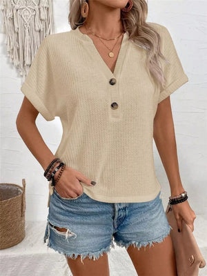 Apricot V-neck waffle knit t-shirt with button detail and short sleeves.
