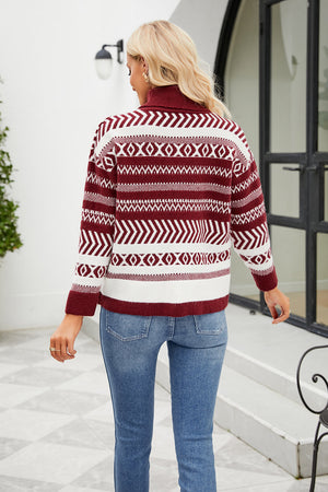 Geometric jacquard turtleneck sweater in deep red and white with long sleeves.