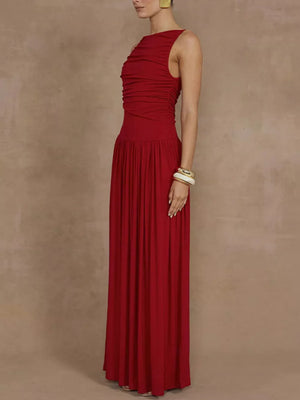 Red ruched maxi dress with asymmetric neckline and flowing skirt.