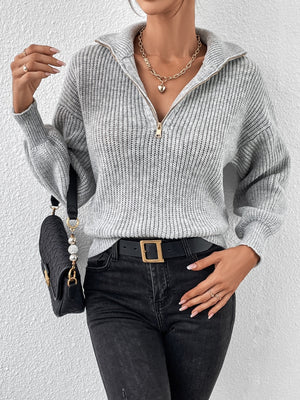 Gray ribbed collar zip-up knit sweater with gold zipper detail.