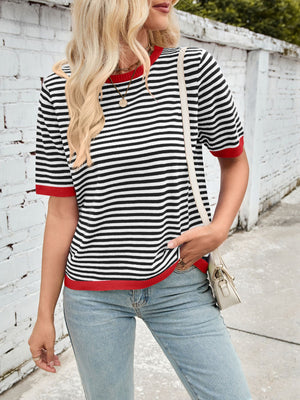 Striped knit tee with red trim and crew neck, styled with light wash jeans.