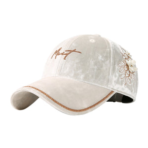 Ivory velvet baseball cap with embroidered floral detail and braided rope trim.