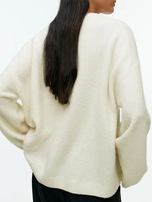 Oversized ivory brushed knit crewneck sweater with ribbed hem and cuffs.