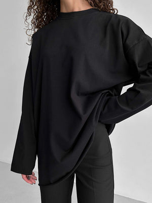 Black oversized cotton jersey top with long sleeves and a relaxed fit.