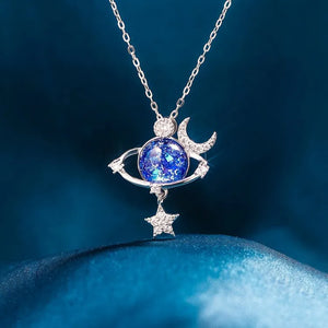 Silver celestial necklace with cosmic orb, moon, and star charms.