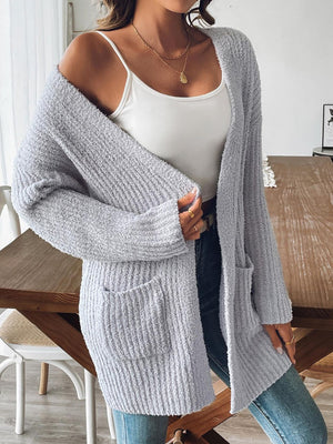 Gray textured bouclé open-front cardigan with pockets and long sleeves.