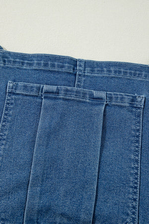Medium wash denim wide-leg overalls with buttoned front and adjustable straps.