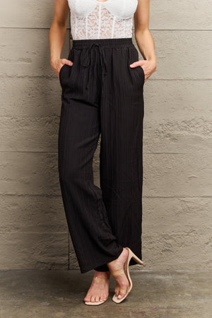 Black ribbed drawstring palazzo trousers with pockets