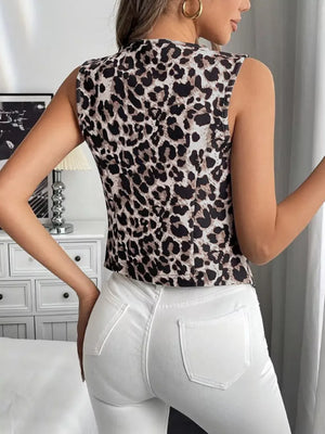 Chic leopard print sleeveless vest coat with a mock neck, worn with white jeans.