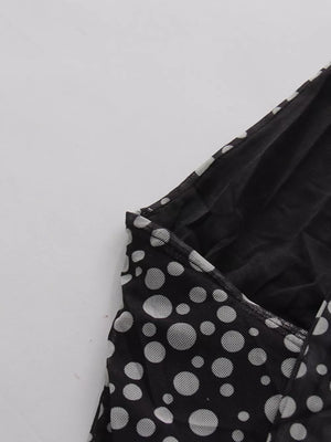 Black polka dot halter maxi dress detail showing mesh fabric and neckline.