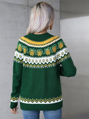 Autumnal Fair Isle crewneck knit sweater in dark green with yellow and white pumpkin pattern.