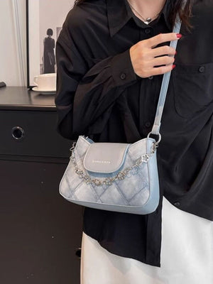 Textured blue shoulder bag with chain strap and quilted detail