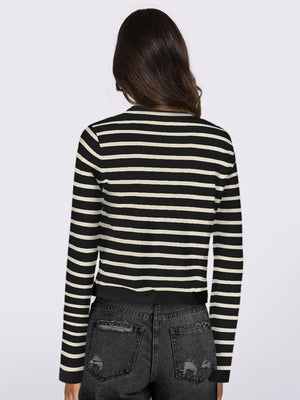 Black and white striped cropped cardigan with long sleeves.