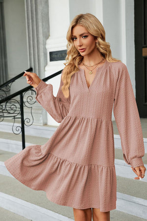 Dusty Pink textured babydoll mini dress with voluminous sleeves and tiered skirt.