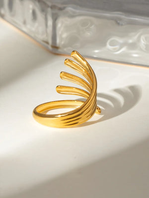 Gold-plated ribbed ring with a sculptural, open design and a smooth band.